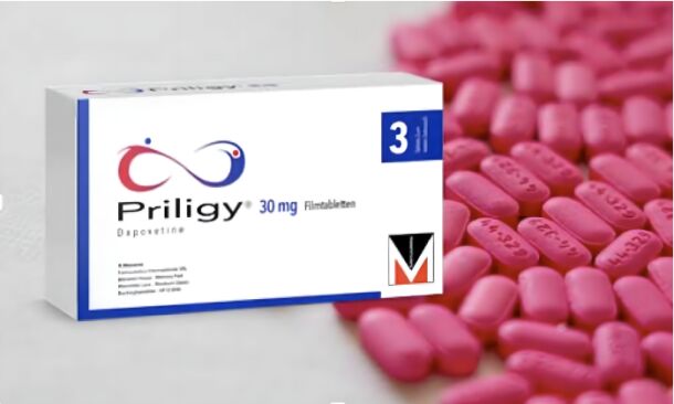 Image d'une boîte de Priligy® 30 mg (Dapoxétine) entourée de comprimés roses. Le Priligy® est utilisé pour traiter l'éjaculation précoce chez les hommes